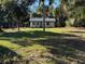Front view of a modest one-story home with large front yard at 3258 S Ridgewood Ave, Edgewater, FL 32141