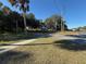 Front yard view from the street with trees and a parked camper at 3258 S Ridgewood Ave, Edgewater, FL 32141