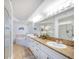 Elegant bathroom with double vanity, jacuzzi tub, and walk-in shower at 3311 S Atlantic Ave # 802, Daytona Beach, FL 32118