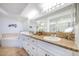 Spacious bathroom with granite countertops and white cabinets at 3311 S Atlantic Ave # 802, Daytona Beach, FL 32118