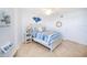Bright bedroom with a queen bed, tile floors, and coastal decor at 3311 S Atlantic Ave # 802, Daytona Beach, FL 32118