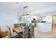 Dining room with a view of the kitchen and six wicker chairs at 3311 S Atlantic Ave # 802, Daytona Beach, FL 32118