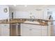 Updated kitchen with granite countertops, stainless steel appliances, and white cabinets at 3311 S Atlantic Ave # 802, Daytona Beach, FL 32118