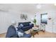 Living room with blue sofa and chair, coastal decor, and ocean view at 3311 S Atlantic Ave # 802, Daytona Beach, FL 32118