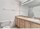 Bathroom with double vanity, large mirror, and toilet at 3313 Celena Cir, St Cloud, FL 34769
