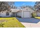 Front view of a house with a garage and landscaping at 3313 Celena Cir, Saint Cloud, FL 34769