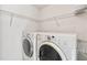 Laundry room with washer, dryer, and storage shelves at 3313 Celena Cir, St Cloud, FL 34769