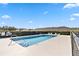 Community swimming pool with lounge chairs at 3313 Celena Cir, St Cloud, FL 34769
