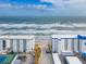 Aerial view shows beachfront location and ocean views at 3606 S Peninsula Dr # 404, Port Orange, FL 32127