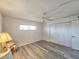 Bright bedroom with wood-look floors, ceiling fan, and ample closet space at 3606 S Peninsula Dr # 404, Port Orange, FL 32127