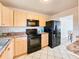 Bright kitchen features black appliances and light wood cabinets at 3606 S Peninsula Dr # 404, Port Orange, FL 32127