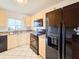 Well-equipped kitchen featuring black appliances and wood cabinets at 3606 S Peninsula Dr # 404, Port Orange, FL 32127
