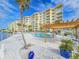 Resort-style pool with adjacent building and relaxing patio at 3606 S Peninsula Dr # 404, Port Orange, FL 32127