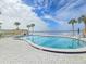 Community pool with waterfront views and relaxing patio area at 3606 S Peninsula Dr # 404, Port Orange, FL 32127