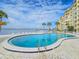 Community pool with water access and a relaxing patio area at 3606 S Peninsula Dr # 404, Port Orange, FL 32127