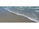 Expansive beach with waves gently lapping the shore at 40 Sandra Cir, New Smyrna Beach, FL 32168