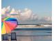 Rainbow umbrella and chairs on the beach at 40 Sandra Cir, New Smyrna Beach, FL 32168