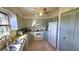 Galley-style kitchen with white appliances and light-colored cabinets at 40 Sandra Cir, New Smyrna Beach, FL 32168