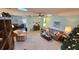 Spacious living room with tiled floors, comfortable seating, and a decorative Christmas tree at 40 Sandra Cir, New Smyrna Beach, FL 32168
