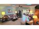 Bright living room features tiled floors, comfy seating, and access to a sunroom at 40 Sandra Cir, New Smyrna Beach, FL 32168