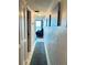 Bright hallway with ocean view and teal runner at 4141 S Atlantic Ave # 605, New Smyrna Beach, FL 32169