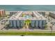 Aerial view of a beachfront condo complex with two buildings, pools, and parking at 4151 S Atlantic Ave # 112, New Smyrna Beach, FL 32169
