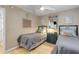 Bedroom featuring twin beds, dresser and light wood floors at 4151 S Atlantic Ave # 112, New Smyrna Beach, FL 32169