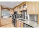 Modern kitchen with stainless steel appliances and light wood cabinets at 4151 S Atlantic Ave # 112, New Smyrna Beach, FL 32169