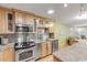 Modern kitchen with stainless steel appliances and light wood cabinets at 4151 S Atlantic Ave # 112, New Smyrna Beach, FL 32169