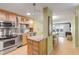 Open kitchen with granite counters, island, and stainless steel appliances at 4151 S Atlantic Ave # 112, New Smyrna Beach, FL 32169