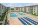 Resort-style pool area with shuffleboard and lounge chairs at 4151 S Atlantic Ave # 112, New Smyrna Beach, FL 32169