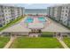 Aerial view of resort-style pool area with spa and ocean view at 4151 S Atlantic Ave # 112, New Smyrna Beach, FL 32169