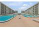 Dual pools with plenty of lounge chairs for sunbathing at 4151 S Atlantic Ave # 112, New Smyrna Beach, FL 32169