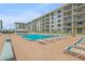 Relaxing pool area with lounge chairs and ocean views at 4151 S Atlantic Ave # 112, New Smyrna Beach, FL 32169