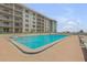 Refreshing beachfront pool with ample lounge chairs at 4151 S Atlantic Ave # 112, New Smyrna Beach, FL 32169