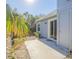 Small patio adjacent to home with tropical landscaping at 4278 Sun Village Ct # 27D, New Smyrna Beach, FL 32169