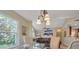 Bright dining area with glass table and three chairs, overlooking the backyard at 4278 Sun Village Ct # 27D, New Smyrna Beach, FL 32169