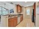 Well-equipped kitchen featuring wood cabinets and granite countertops at 4278 Sun Village Ct # 27D, New Smyrna Beach, FL 32169