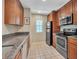 Kitchen with stainless steel appliances and wood cabinets at 4278 Sun Village Ct # 27D, New Smyrna Beach, FL 32169