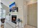 Cozy living room with fireplace, TV, and built-in shelving at 4278 Sun Village Ct # 27D, New Smyrna Beach, FL 32169