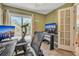 Home office with a desk, computer monitors, and exercise bike at 4278 Sun Village Ct # 27D, New Smyrna Beach, FL 32169