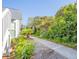 Sidewalk leads to home entrance, lush landscaping surrounds at 4278 Sun Village Ct # 27D, New Smyrna Beach, FL 32169