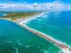 Aerial view of jetty extending into ocean waves at 4670 Links Village Dr # C402, Ponce Inlet, FL 32127
