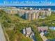 Aerial view of coastal community, featuring oceanfront building and lush landscaping at 4670 Links Village Dr # C402, Ponce Inlet, FL 32127