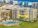 Aerial view of The Links South at Harbour Village, showing building and pool at 4670 Links Village Dr # C402, Ponce Inlet, FL 32127