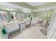 Large bathroom with double sinks, garden tub, and separate shower at 4670 Links Village Dr # C402, Ponce Inlet, FL 32127
