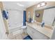 Clean bathroom with white vanity, tub, and shower at 4670 Links Village Dr # C402, Ponce Inlet, FL 32127