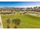 Scenic view of a lush green golf course with palm trees at 4670 Links Village Dr # C402, Ponce Inlet, FL 32127