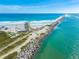 Aerial view of a jetty with lifeguard stand and beachgoers at 4670 Links Village Dr # C402, Ponce Inlet, FL 32127