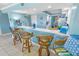 Kitchen features breakfast bar with wicker stools at 4670 Links Village Dr # C402, Ponce Inlet, FL 32127